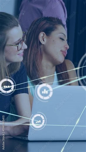 Vertical video: Two women typing at laptop, spawning globe chart node overlay mapping tech data