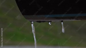 Dripping water flows from a large discharge pipe of polluted contaminated danger waste