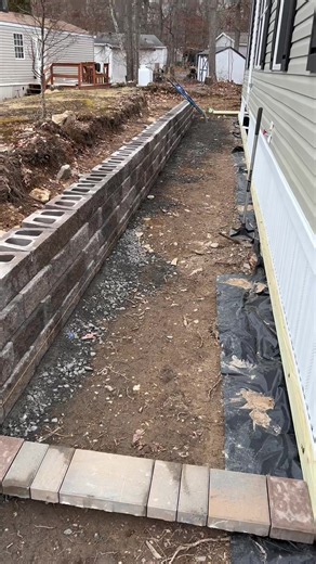 Retaining wall with lights and techo bloc paver walkway project for a new home we are completing. #contractor #construction #contractorsoftiktok #heavyequipment #paving #caterpillar #retainingwall #pavers #hardscape #miniexcavator #manufacturedhomes #doublewide #newhome #paver