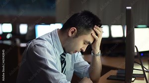 Annoyed businessman sitting in front of computer monitor