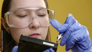 Professional technician girl installing new hard drive into desktop pc at work place. Static shot. 4K UHD