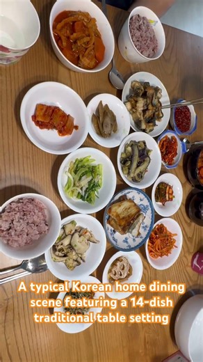A typical Korean home dining scene featuring a 14-dish traditional table setting