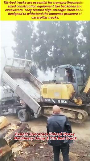 Expert Operators Unload Heavy Machinery Using A Tilt Bed Truck