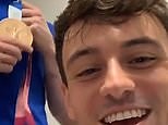Tom Daley messes around with fellow GB medal winning diver Jack Laugher