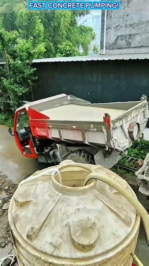 Self-Loading Concrete Mixer Feeding Concrete Pump in Action.