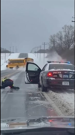 Cop slips on ice school bus crashes into ditch