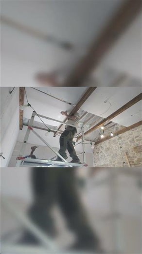 Heavy lifting plasterboard with my apprentice