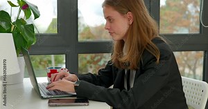 Pretty girl office worker doing her job on a laptop