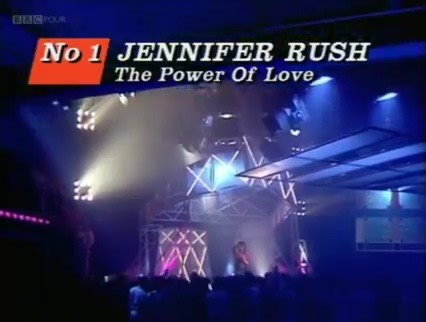 Number ❶: 5 Weeks in 1985 🔝 Jennifer Rush ~ The Power Of Love Possibly the quintessential power-ballad, in all its pompous, bombastic glory. 'The Power of Love' concerns itself with love's zenith. Jennifer is a woman unafraid of laying out her raw emotions to the world. The ambient first lyric, "Whispers in the morning, of lovers sleeping tight…. are rolling like thunder now, as I look in your eyes", brings us to the table. In my minds eye, I can almost see the curtains fluttering in the mornin