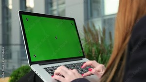 Women hands working on laptop green screen. Woman using notebook with chroma key. Person fingers typing a computer keyboard. Business, communication, freelance and internet concept. Lady