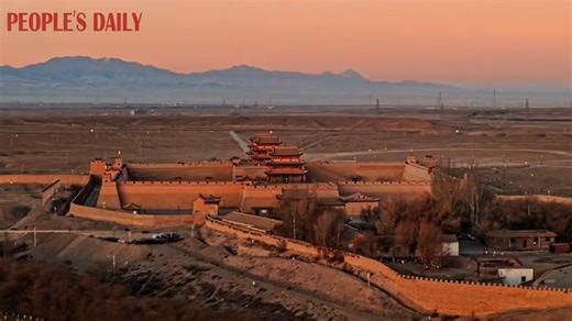 The rising sun casts a captivating glow over the Jiayu Pass scenic area, highlighting the charm of traditional architecture against the vastness of nature in northwest China's Gansu Province. #BeautifulChina | People's Daily, China