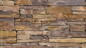 Wall of stacked thin natural stones. Ledgestone decorative cladding blocks background