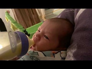 Baby tries bottle feeding for the first time