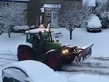 Snow plough clears heavy snow from a residential street