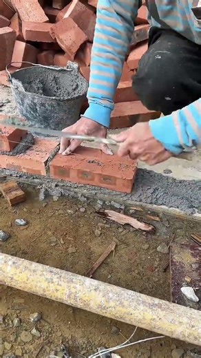 Skilled Bricklayer Carefully Sets Red Bricks For Strong Wall Foundation
