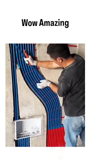 explainingproduction on Instagram: "The video captures a time-lapse of an electrician embedding flexible PVC conduits—red for power, blue for data—into a concrete wall using a hammer drill, highlighting efficient pre-wiring for modern buildings. This technique ensures organized cable routing, allowing future upgrades without wall demolition and complying with standards like NEC Article 358 for safety. PVC conduits reduce fire risks by containing sparks and provide corrosion resistance, cutting i