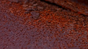 Download Rusty painted metal surface. Macro view of corrosion in iron metal, texture background. Smooth slow motion for free