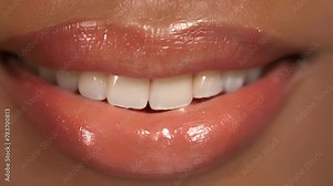 A hint of teeth showing through a parted smile adding a playful element to the lips. .