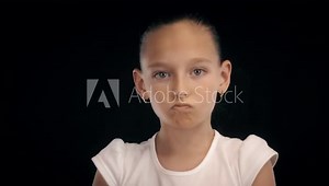 Portrait angry teenager girl clenched fists making kick with leg on black bacground