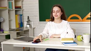 Girl pupil got anxious after using laptop computer and take mobile phone at lesson, study