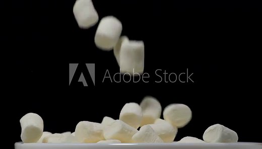 Pile of soft marshmallows falling. Sweet marshmallow falls from top to bottom.