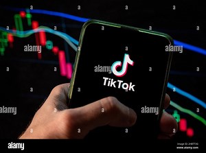 China. 4th Dec, 2021. In this photo illustration the Chinese video-sharing social networking service company TikTok logo seen displayed on a smartphone with an economic stock exchange index graph in the background. (Credit Image: © Budrul Chukrut/SOPA Images via ZUMA Press Wire Stock Photo - Alamy