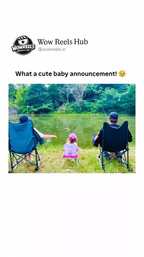 Wow Reels Hub™ on Instagram: "This short video captures a heartwarming family fishing trip by a serene pond surrounded by lush green trees, where a couple and their little daughter in a pink hat and outfit sit in camping chairs, casting lines into the calm water. The dad, in a baseball cap and dark jacket, helps the toddler hold her tiny rod, while the mom reels in her line with building excitement, standing up as something tugs at the end. The scene builds anticipation amid the peaceful outdoor