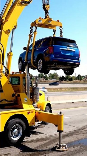 Watch a tow truck lift cars