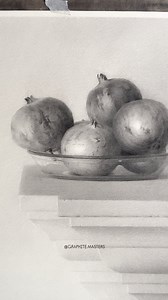 Graphite still life study of pomegranates by artist Fu Laosi’er (Douyin) — a beautifully balanced composition showcasing refined tonal control and keen observation. Subtle value shifts model the spherical forms with realism, while crisp edges and soft shadows create depth and quiet harmony. The simplicity of the setup allows texture, light, and form to take center stage. Artist: Fu Laosi’er (Douyin) #graphitedrawing #stilllifedrawing #pomegranates #realismart #graphitestudy | Graphite Masters