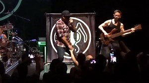 Singer Dryden Mitchell appears to pull fan's hand to his genitals