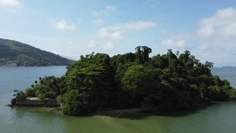 clip-4000986563-drone-rises-behind-small-tropical-island-covered