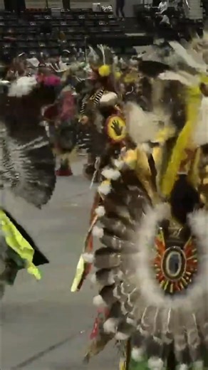 Native American dancers put on a performance in an arena as spectators gather to watch. https://www.powwowtimes.ca #NativeAmerican #Dancers #Performance #Spectators #Arena | Powwow Times