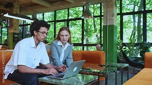 Video of a business situation with employees and working colleagues team up to work on different projects in a coworking office