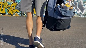Opened backpack filled with spray paint is getting taken off the ground and carried away by an artist