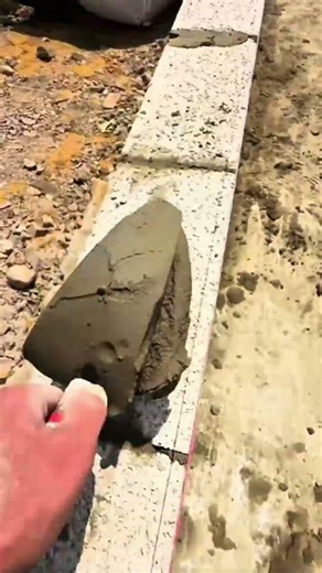 Cut the cement mixture with a triangular trowel to be applied to the wall #construction #viralshorts