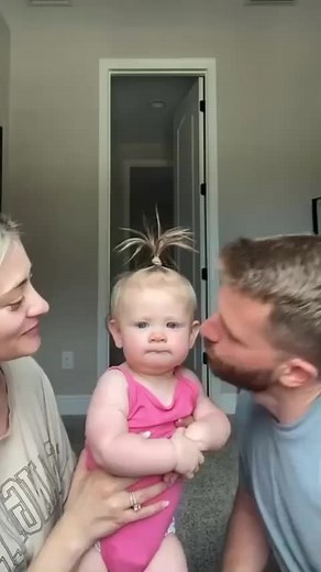 Adorable Baby Kissed by Loving Parents - Heartwarming Moment!