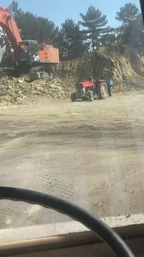 Excavator and Tractor in Action at Construction Site