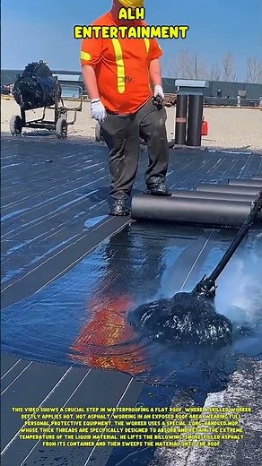 Professional roof installation: manually applying hot asphalt using a special mop