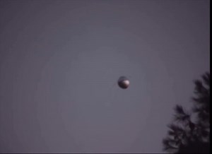 In 2014, retired DoD employee Rick Ybarra filmed a reflective metallic sphere hovering near his San Diego home that appeared to defy wind movement, shift direction abruptly, and display antenna-like appendages. | Disclosure Party
