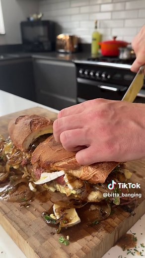 Roast Beef au Jus Sambo 🫡 Started with a base of a mozzarella roll then added: • Mustard mayo • Roast beef dunked in au jus • Brie • Sautéed onions • Parsley • More au jus #fyp #food #foodporn #foodtiktok #foodie #beef #sandwich #cheese #chef