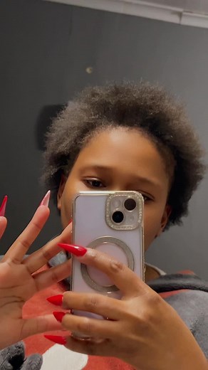 Showcasing Stylish Long Red Nails with Curly Hair