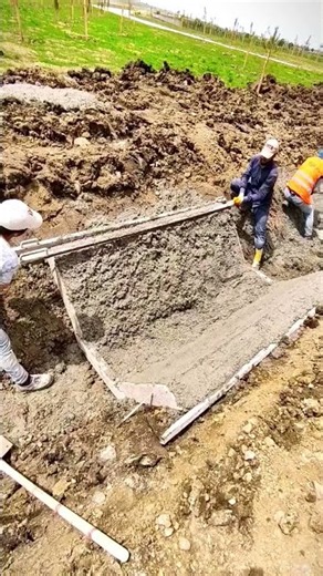 Screeding Wet Cement in Slope Trench
