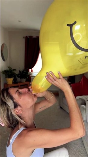 Cute Blonde Looner Girl Blows up Yellow Smiley Balloon