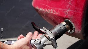Hand Using LPG Filling Nozzle to Refuel Car at Autogas Filling Station. Filling Up the Gas Tank. Refueling with Liquefied Petroleum Gas. LPG Prices. LPG Filling Station Equipment.