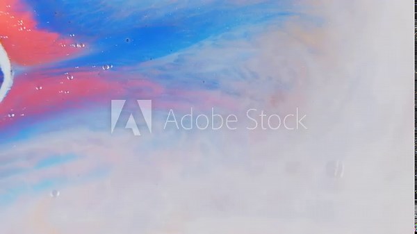 Swirling colors of ink diffusing in water, creating an abstract art effect with vibrant hues