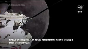 NASA's moon capsule heads home, overflies history
