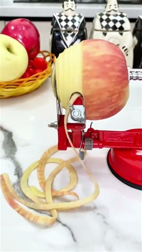 peeling the apple with rotary tool until the skin is peeled and the apple is split into small pieces
