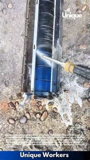 Deep Cleaning Air Conditioner: Man Power-Washes Dirt and Grime from Outdoor Unit