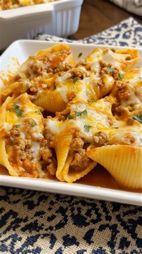 Cheesy Stuffed Shells Tender pasta shells filled with creamy ricotta, mozzarella, and herbs, nestled in rich marinara sauce and topped with more cheese, a timeless baked pasta favorite. Ingredients: 20 jumbo pasta shells 1 (15 oz) container ricotta cheese 1 ½ cups shredded mozzarella cheese, divided ½ cup grated Parmesan cheese 1 egg 1 tsp Italian seasoning Salt and pepper to taste 3 cups marinara sauce Fresh basil or parsley (optional) Instructions: Preheat oven to 375°F (190°C). Boil shells to