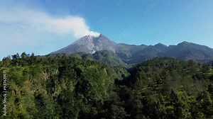 4k aerial footage Panorama of Mount Merapi in the morning from close range with beautiful views in summer in the morning. Aerial landscape of volcano with forest and green hills in front Stock Video